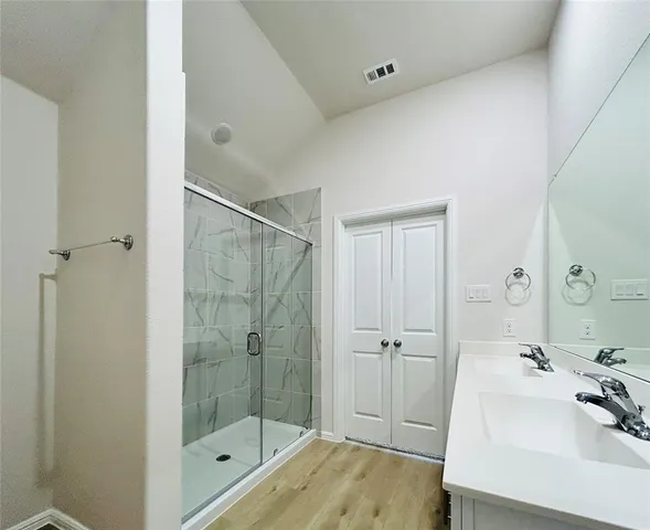 a bathroom with a sink a toilet and shower