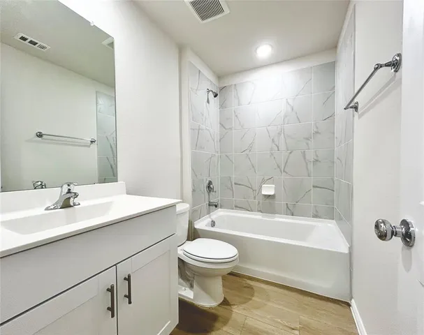 a bathroom with a sink a toilet and a bathtub