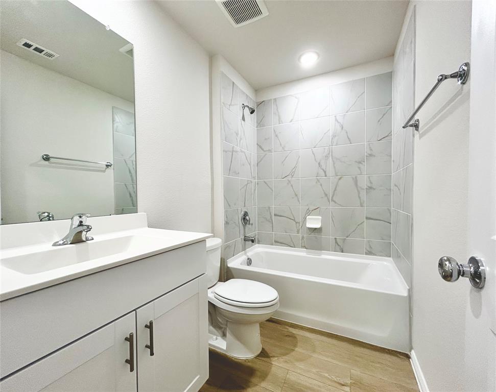 2505 McNally Drive Mesquite, TX 75181 - Photo 20 of 28 a bathroom with a sink a toilet and a bathtub