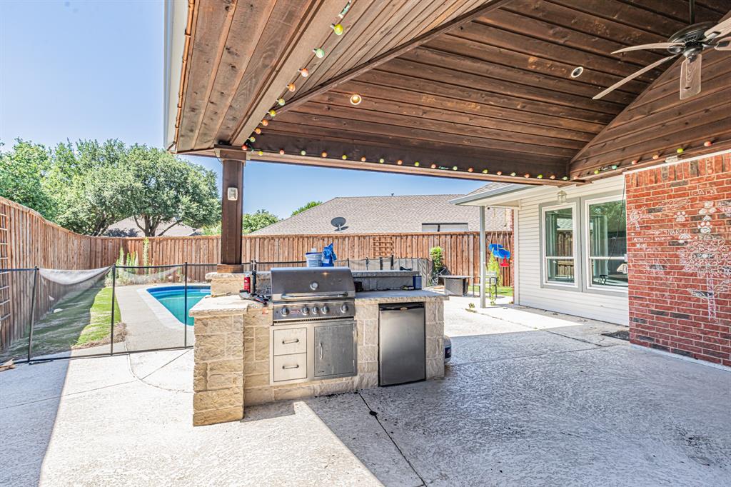 300 Sundance Circle Irving, TX 75063 - Photo 33 of 39 Covered patio featuring a wood-plank ceiling and a built-in outdoor kitchen