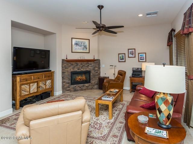 1636 Constable Street Prescott, AZ 86301 - Photo 11 of 33 a living room with furniture a flat screen tv and a fireplace