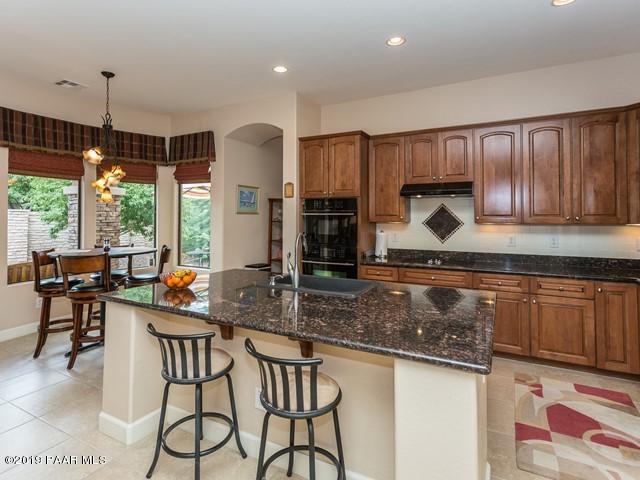 1636 Constable Street Prescott, AZ 86301 - Photo 14 of 33 a kitchen with stainless steel appliances granite countertop wooden cabinets a stove a sink and a granite counter tops
