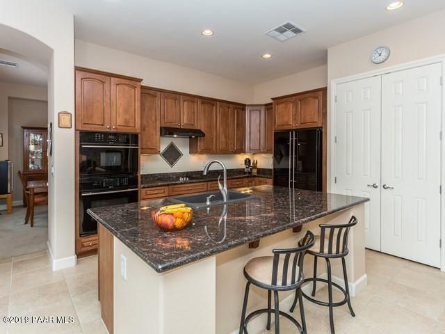 1636 Constable Street Prescott, AZ 86301 - Photo 15 of 33 a kitchen with granite countertop a stove refrigerator and microwave