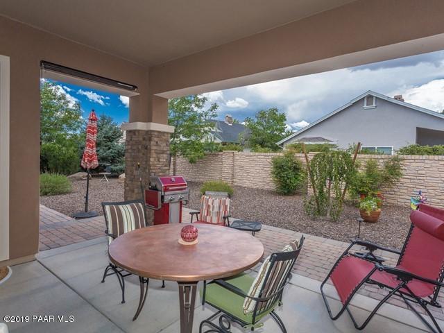 1636 Constable Street Prescott, AZ 86301 - Photo 26 of 33 a view of a patio with a table chairs and a backyard