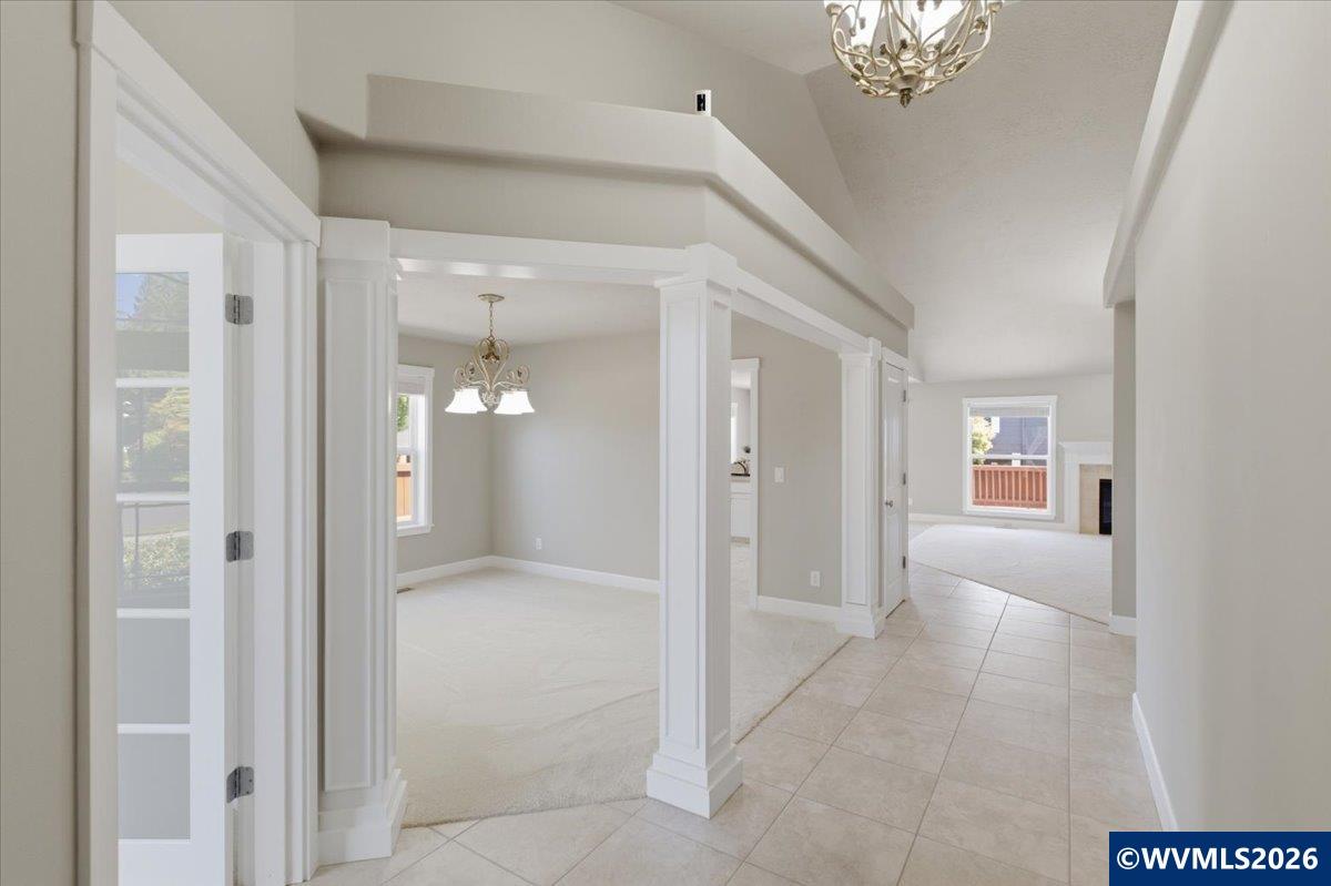 2359 Northwest Gale Street Albany, OR 97321 - Photo 5 of 47 a view of a hallway with a chandelier fan and windows