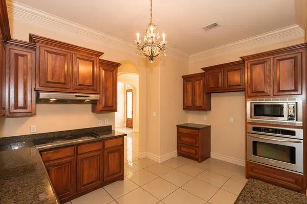 a kitchen with stainless steel appliances granite countertop a stove and cabinets