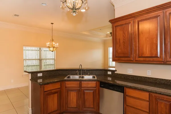 a kitchen with granite countertop a sink and cabinets
