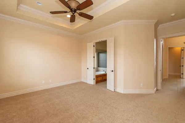 an empty room and chandelier fan