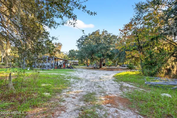 a view of a house with a backyard