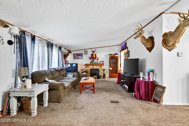 a view of livingroom with furniture and a flat screen tv