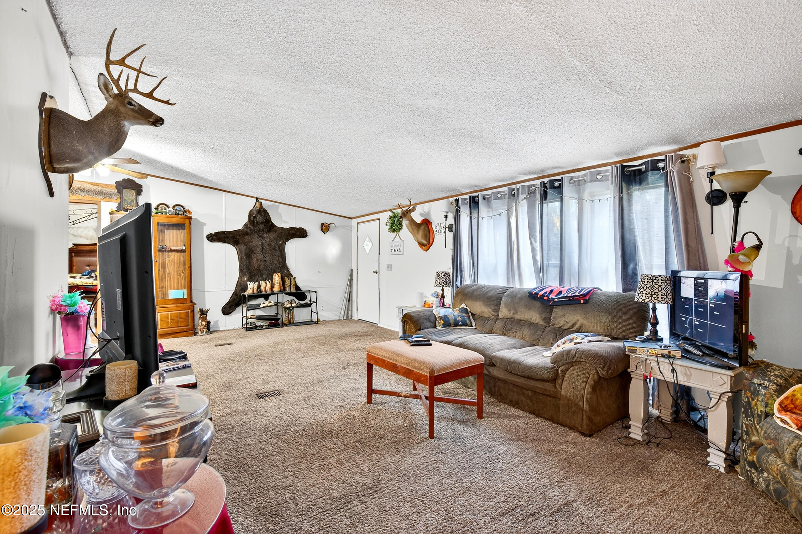 133 Rainbow Road Crescent City, FL 32112 - Photo 18 of 31 a living room with furniture a window and gym equipment