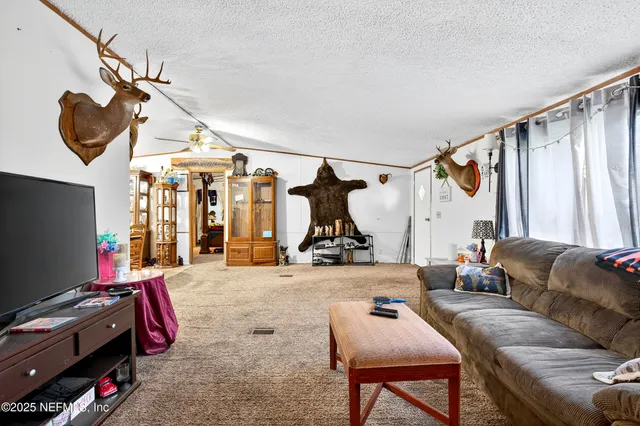 a kitchen with granite countertop a refrigerator and a stove top oven
