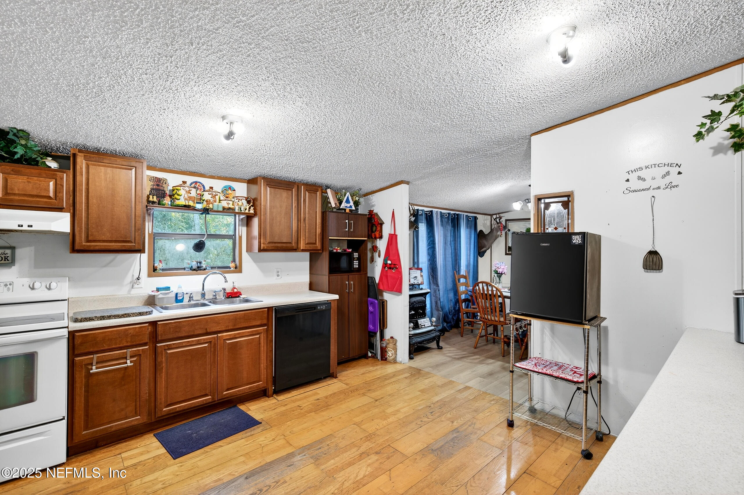 133 Rainbow Road Crescent City, FL 32112 - Photo 22 of 31 a kitchen with stainless steel appliances kitchen island granite countertop a sink and cabinets