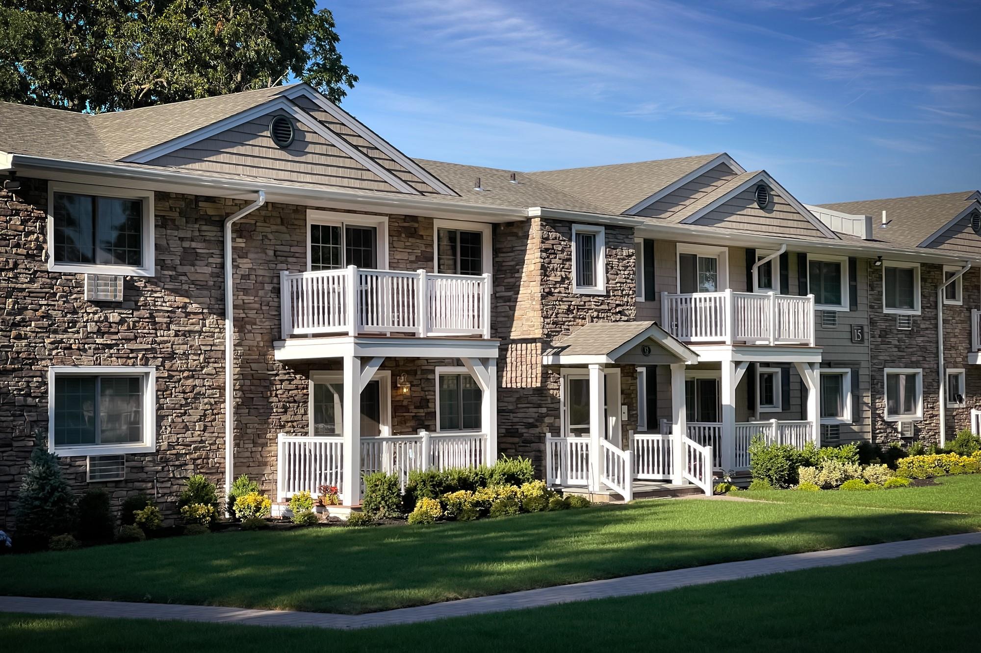 25 Williams Boulevard, Unit 252F Lake Grove, NY 11755 - Photo 3 of 12 a front view of a house with a yard
