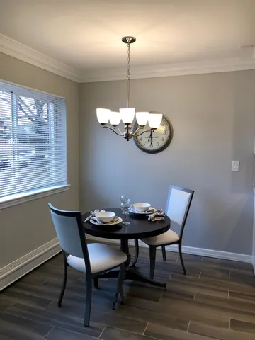 a view of a dining room with furniture wooden floor and chandelier