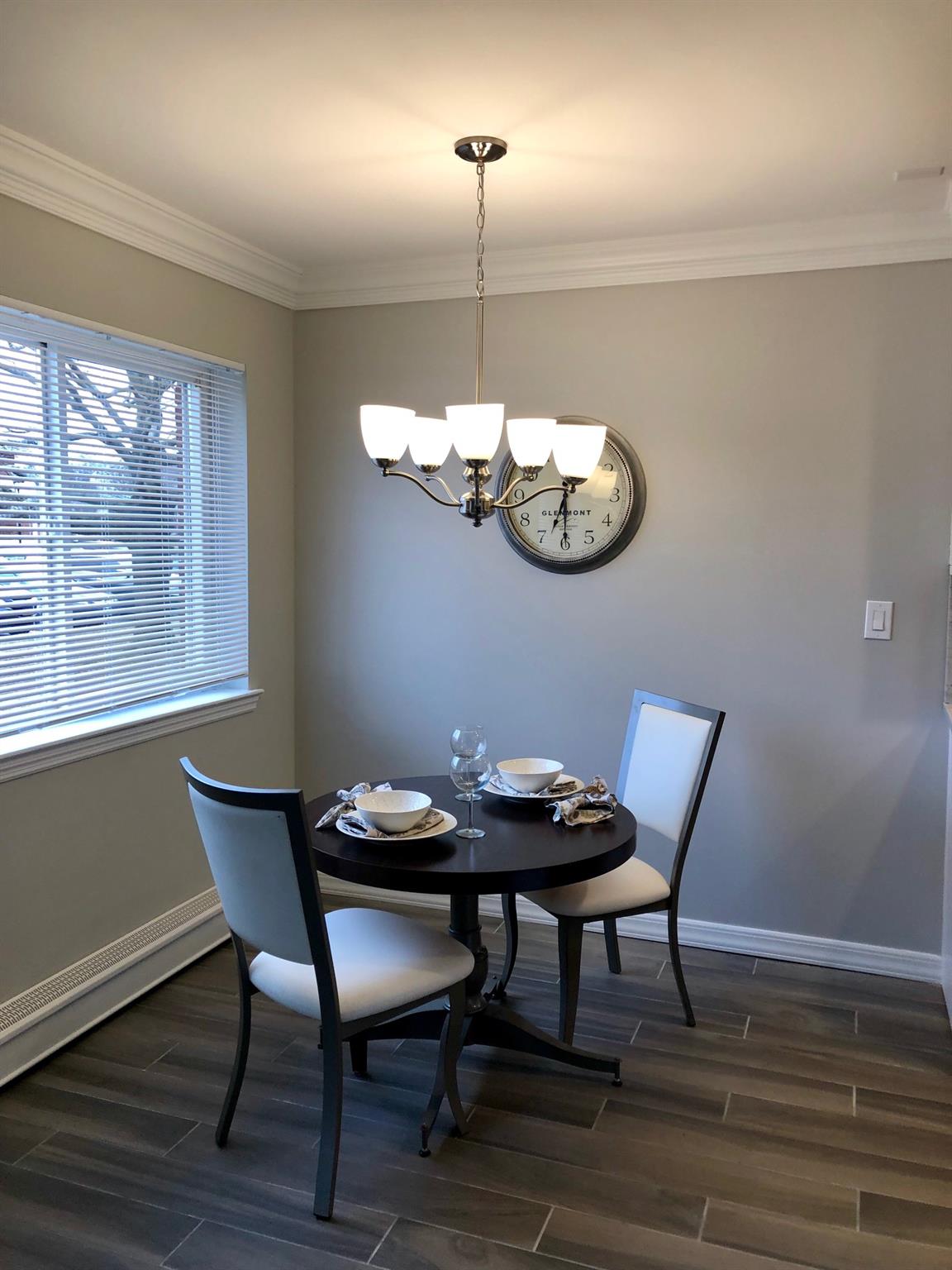 25 Williams Boulevard, Unit 252F Lake Grove, NY 11755 - Photo 6 of 12 a view of a dining room with furniture wooden floor and chandelier