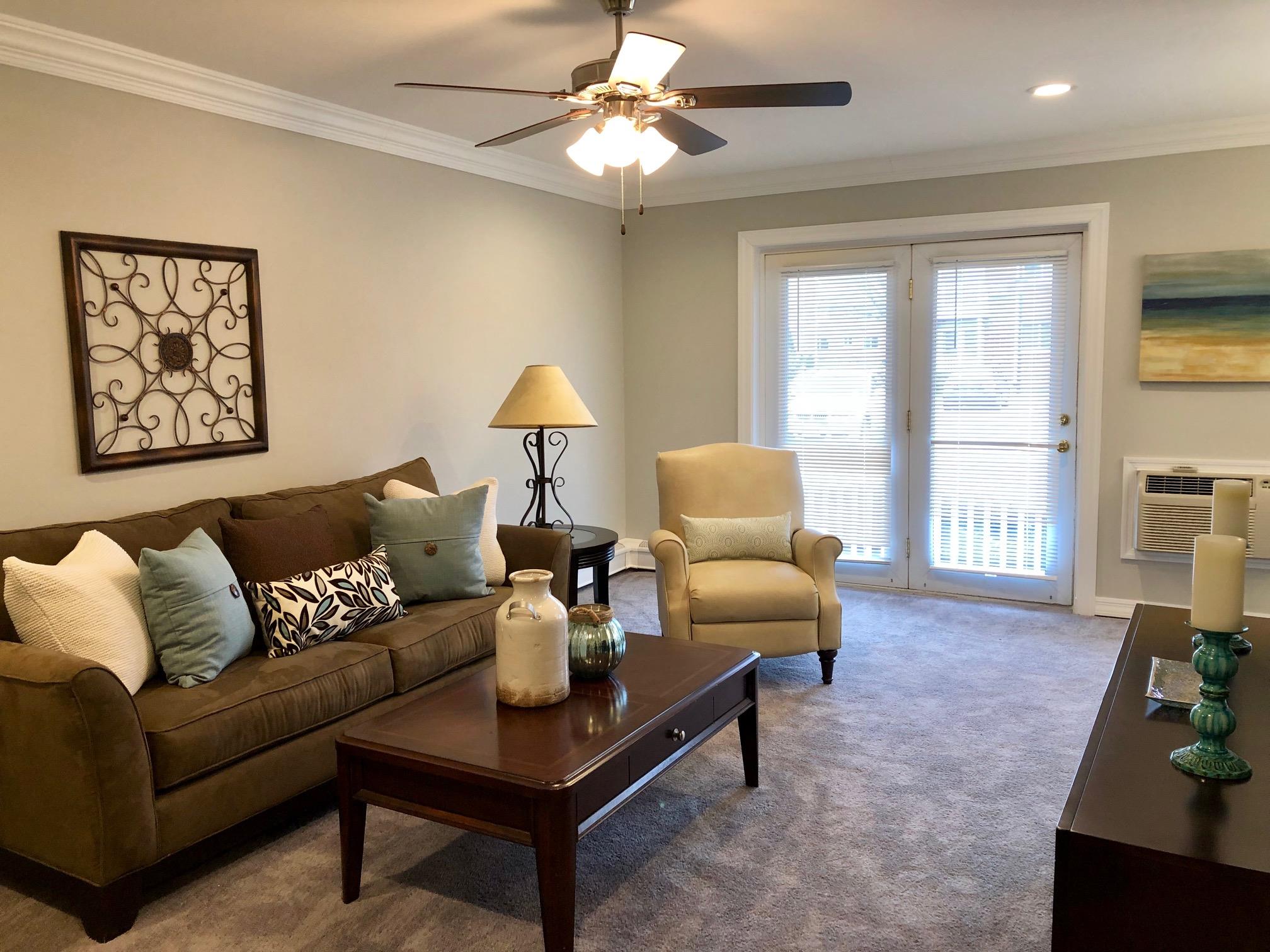 25 Williams Boulevard, Unit 252F Lake Grove, NY 11755 - Photo 7 of 12 a living room with furniture and a large window