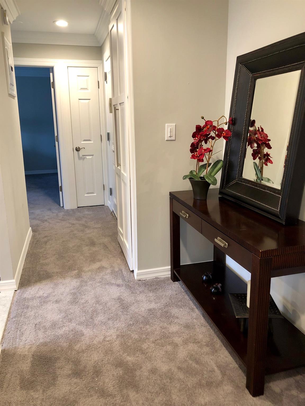 25 Williams Boulevard, Unit 252F Lake Grove, NY 11755 - Photo 9 of 12 a view of hallway with wooden floor and stairs