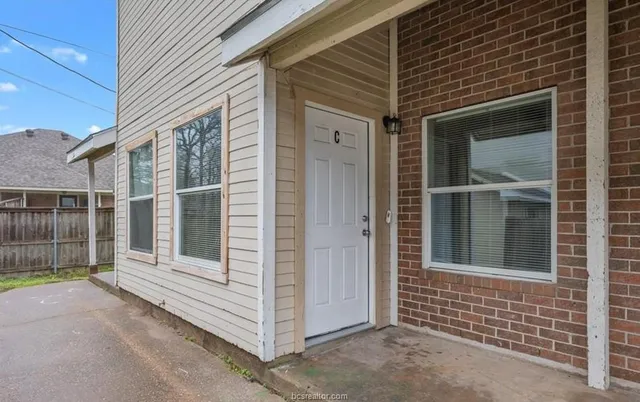a view of empty room with wooden floor and fireplace