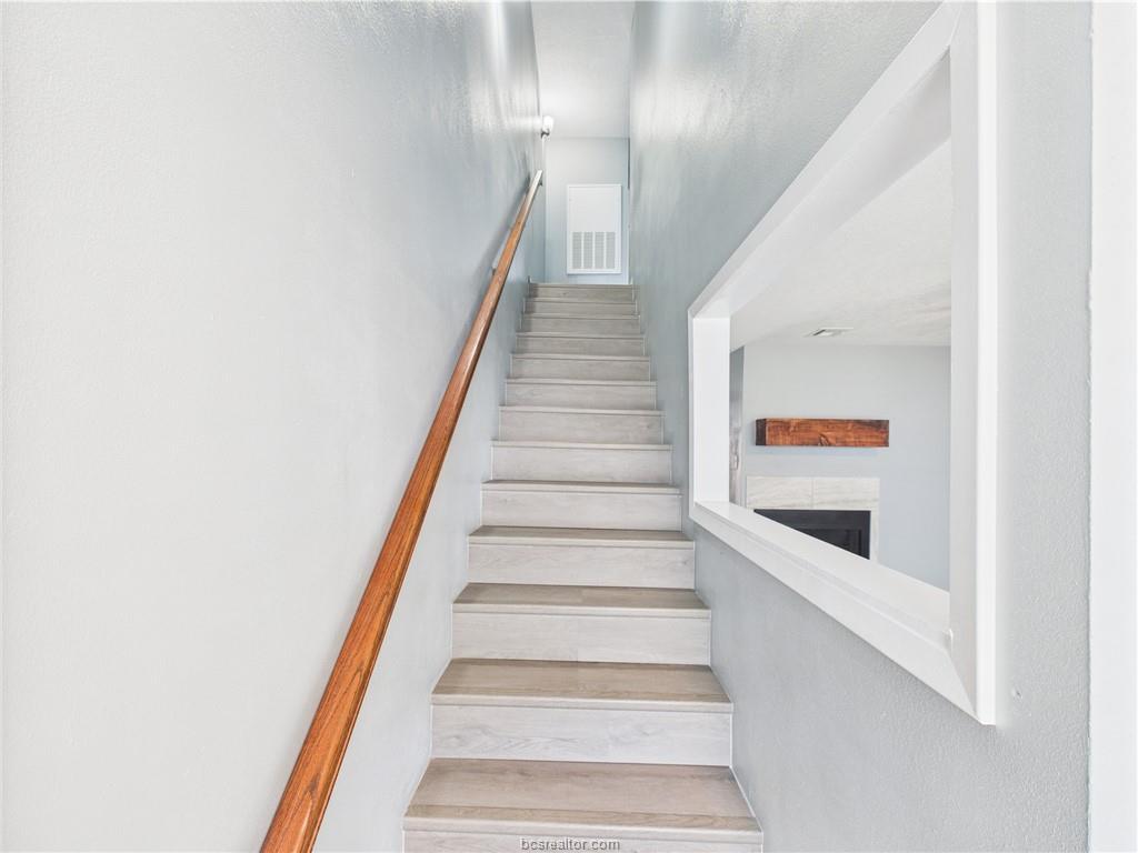 1104 Verde Drive, Unit A Bryan, TX 77801 - Photo 5 of 11 a view of staircase with lots of frames on wall