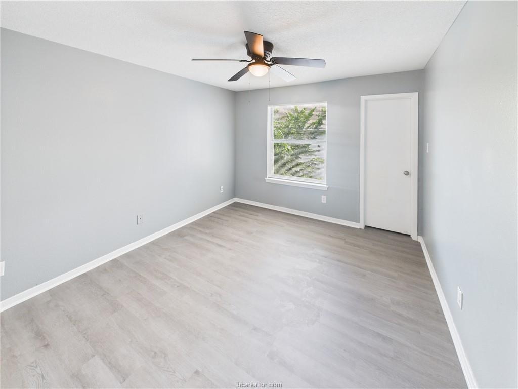 1104 Verde Drive, Unit A Bryan, TX 77801 - Photo 7 of 11 an empty room with window and a ceiling fan