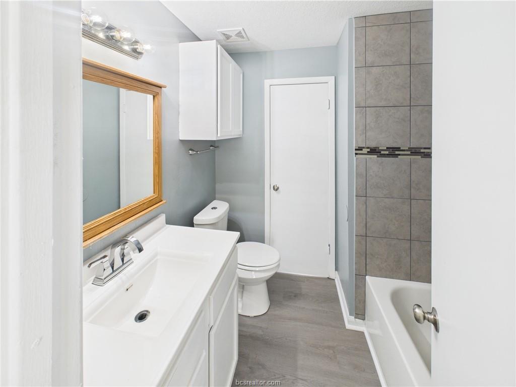 1104 Verde Drive, Unit A Bryan, TX 77801 - Photo 8 of 11 a bathroom with a sink a toilet and shower