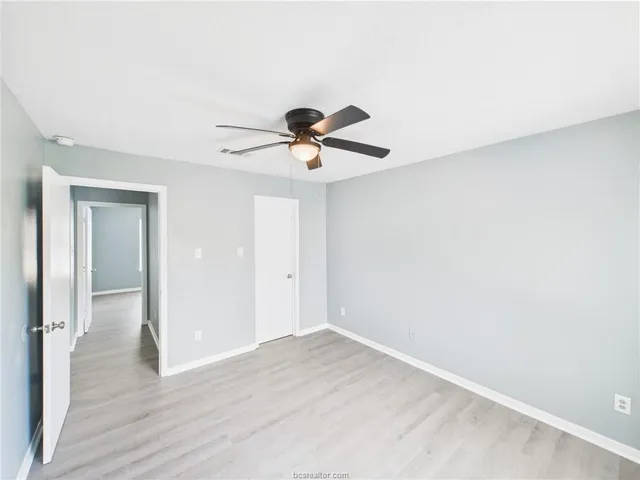 a view of a livingroom with a ceiling fan and wooden floor