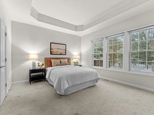 a spacious bedroom with a bed and a large window