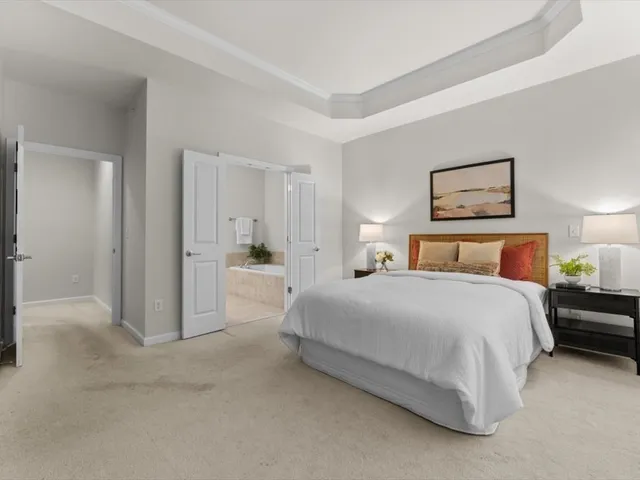 a bedroom with a bed and a painting on the wall