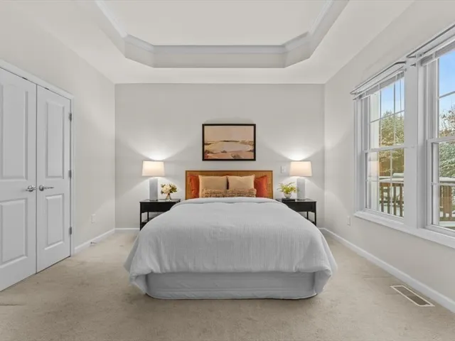 a bedroom with a bed and a large window