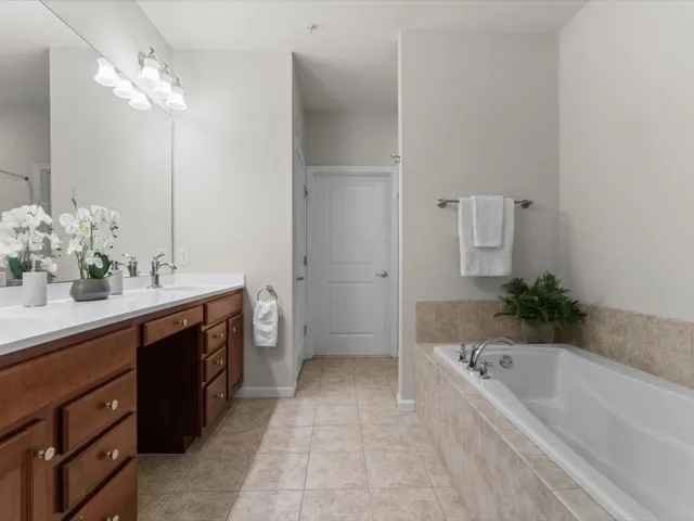 a bathroom with a bathtub a sink and a mirror