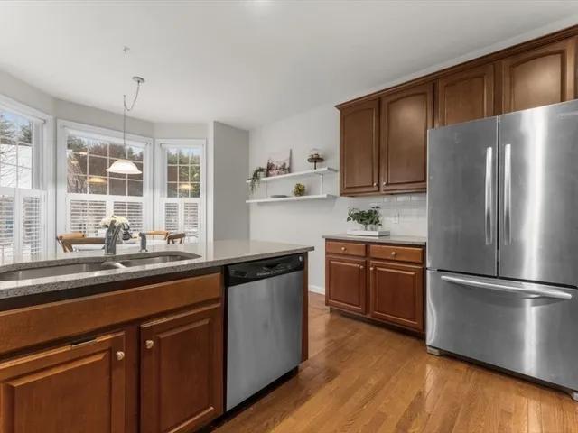 a kitchen with a refrigerator and a sink