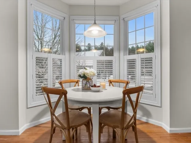 a dining room with furniture and window