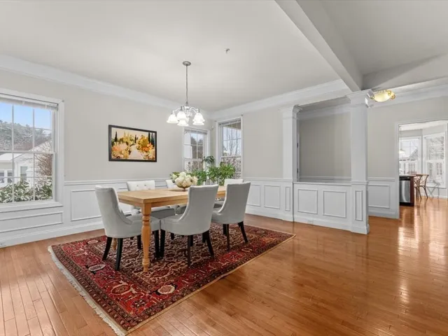 a view of a dining room with furniture wooden floor and chandelier