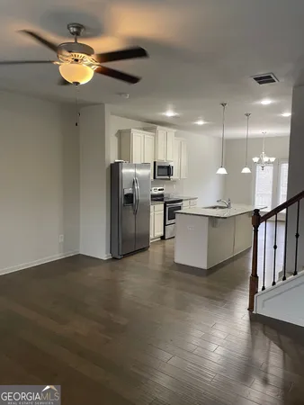 a view of a kitchen with a sink stainless steel appliances and cabinets