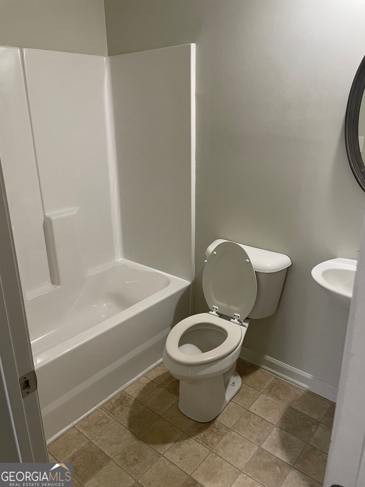 3810 Equity Lane Powder Springs, GA 30127 - Photo 15 of 32 a toilet sitting in a bathroom next to a sink