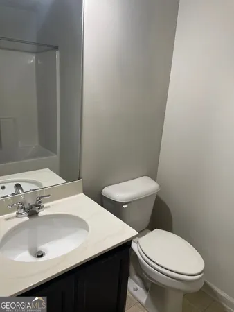 a bathroom with a sink a toilet and mirror