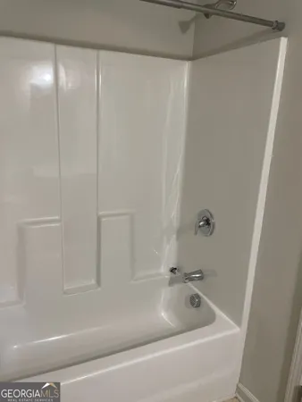 a bathroom with a tub and shower