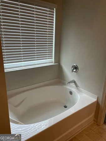 a bathroom with a glass shower door and a sink