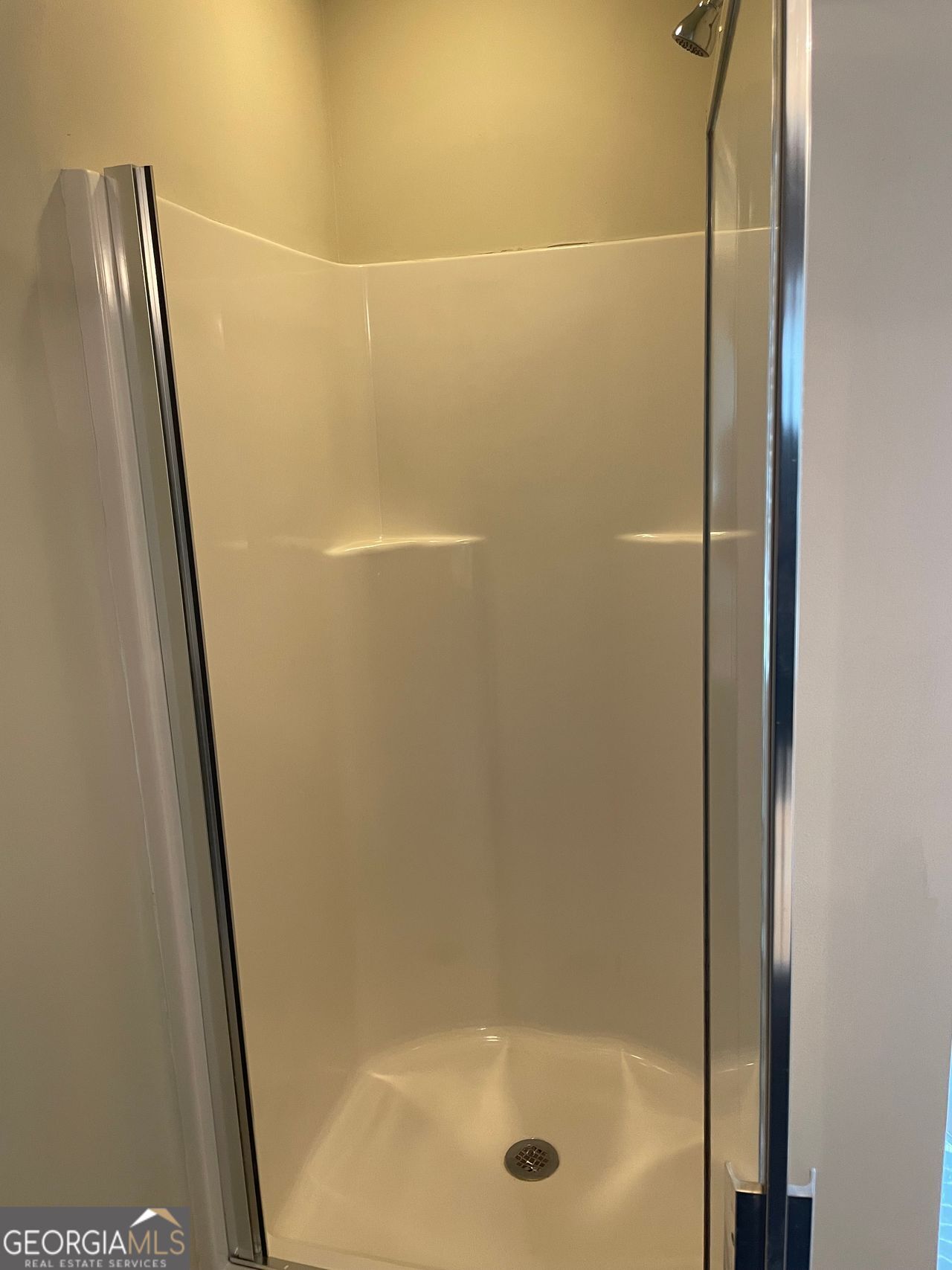 3810 Equity Lane Powder Springs, GA 30127 - Photo 28 of 32 a bathroom with a glass shower door and a sink