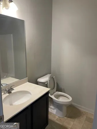 a white toilet sitting next to a bathroom sink