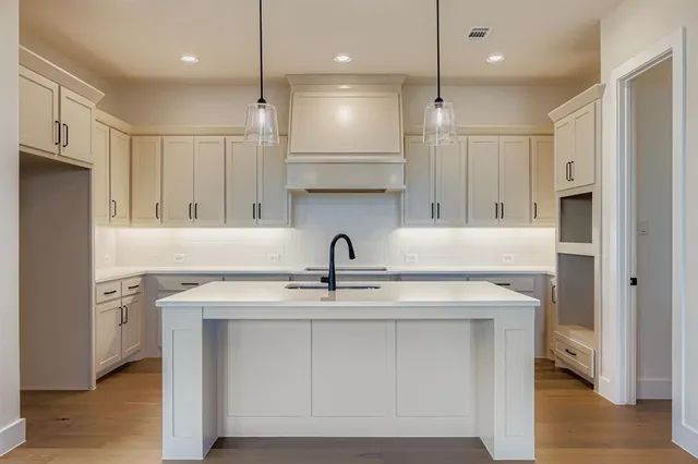 a kitchen with a sink appliances and cabinets