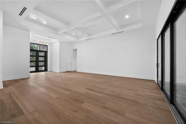 a living room with furniture a rug and a potted plant