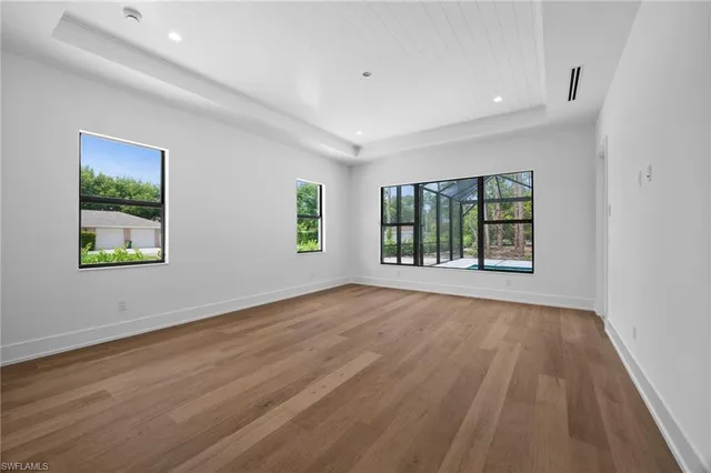 a living room with furniture large window and flat screen tv