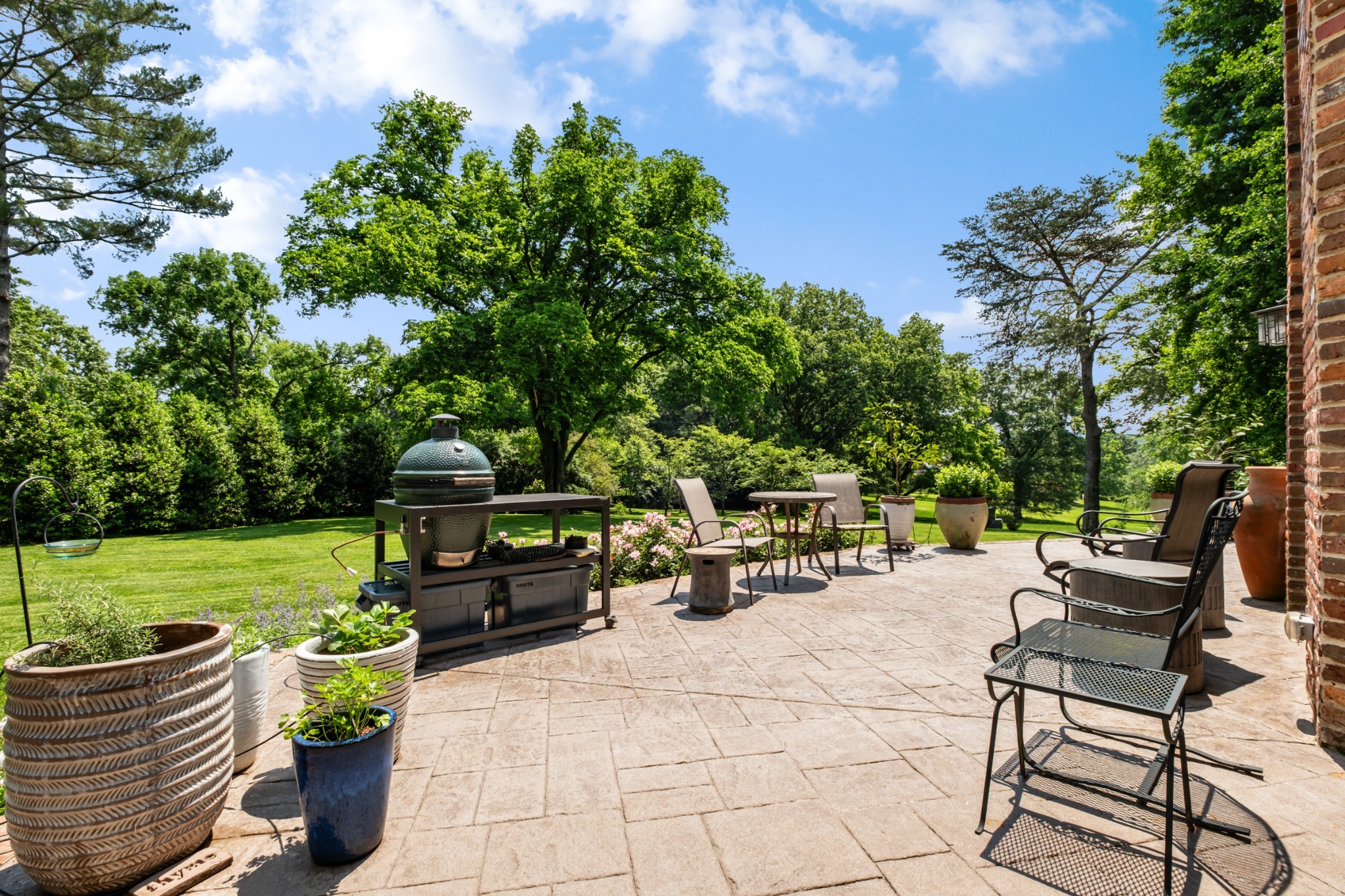 140 Brook Hollow Road Nashville, TN 37205 - Photo 26 of 31 a view of a patio with dining table and chairs with a garden