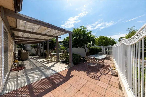 a view of a patio with table and chairs and potted plants