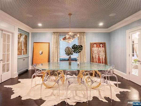a living room with patio furniture and a potted plant