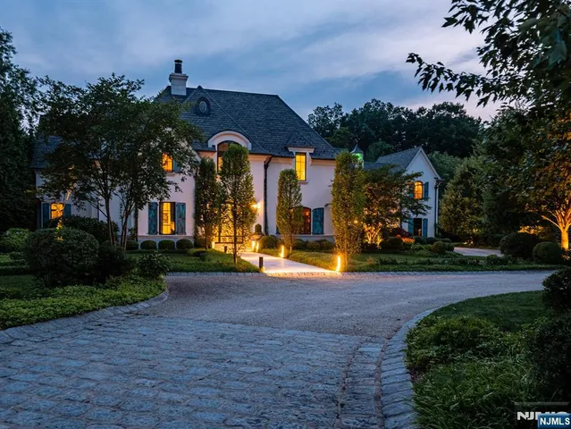 a living room with furniture a chandelier and a large window