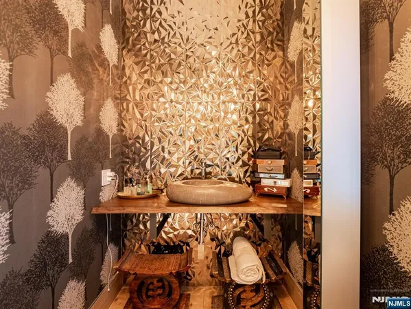 a front view of a house with garden and sitting area