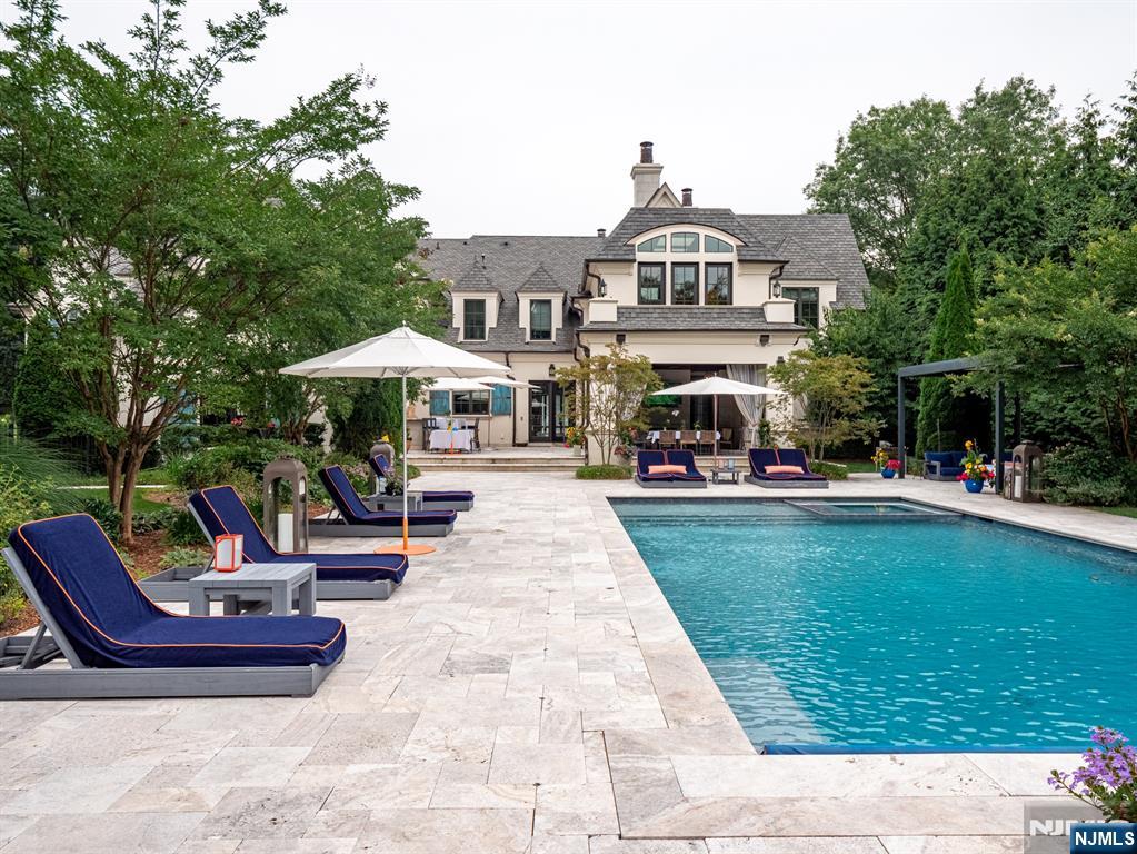 7-11 Stokes Farm Road Old Tappan, NJ 07675 - Photo 34 of 40 a front view of a house with garden and sitting area